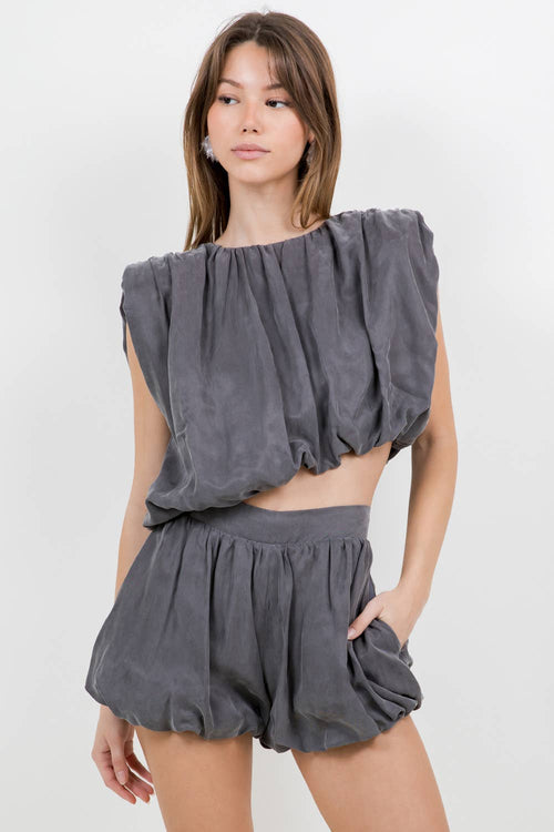 ASYMMETRICAL HEMMED WITH SHOULDER PAD WOVEN TOP - CHARCOAL