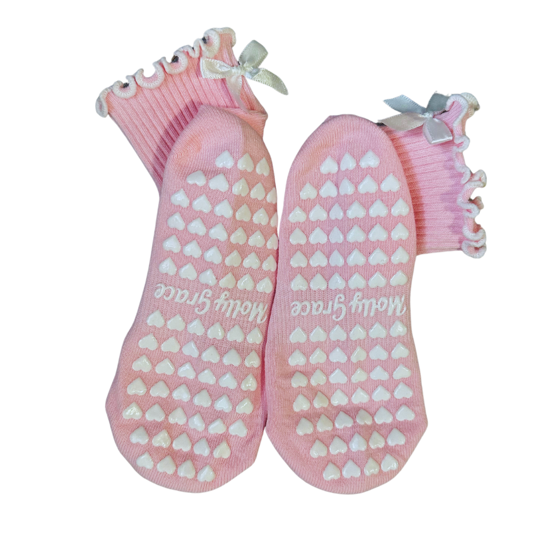 Light pink ruffle grip socks with white bow